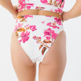 Back view of Villa Almost Cheeky Bottoms showcasing a white and pink floral print with an almost-cheeky fit on a model