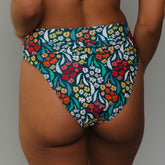 Rear view of Costa Floral Almost Cheeky Bottoms showcasing a multicolor floral print on a model against a gray background
