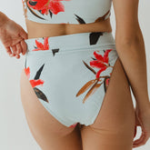 Close-up view of Sea Glass Almost Cheeky Bottoms showcasing the floral print, high-rise waistband, and cheeky fit on a model