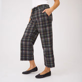 Side view of Audrey Mid Rise Wide Leg Pants in Aspen Plaid showcasing the wide-leg fit on a model against a white background