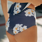 Close-up rear view of navy floral Daisy High-Waisted Bottoms showcasing high waist and fitted coverage on model