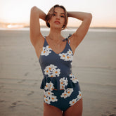 Front view of Daisy High-Waisted Bottoms showcasing the high-waisted floral design on a model at the beach