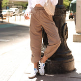 Front view of Jetsetter Cargo Joggers in chestnut showcasing cargo pockets and elastic cuffs on a model beside a city fire hydrant