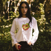 Front view of Disney Bell Long Sleeve Tee, Poison Apple showcasing colorful poison apple graphic outdoors