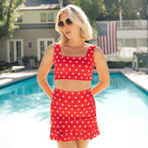 Front view of Star Olivia Swim Crop showcasing a red star print and square neckline on a model by a pool