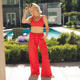 Front view of Slip On Trouser, Star showcasing red star print and wide-leg fit with a poolside background