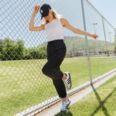 Side view of black Jetsetter Cargo Joggers showcasing cargo pockets and tapered cuffs on a model outdoors