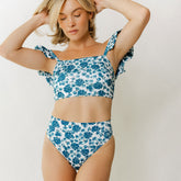 Front view of Santorini Almost Cheeky Bottoms showcasing blue floral print and high-rise fit on a model against a light background
