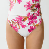 Front view of Villa Almost Cheeky Bottoms showcasing a white base, pink floral print, and almost cheeky fit on a model