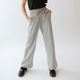 Front view of heather light grey Audrey Trouser showcasing wide legs, drawstring waistband and side pockets on white background