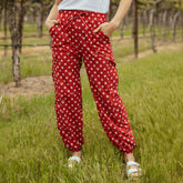 Front view of Disney Cargo Joggers, Red Minnie Dot showcasing cargo pockets and elastic cuffs with a grassy outdoor background