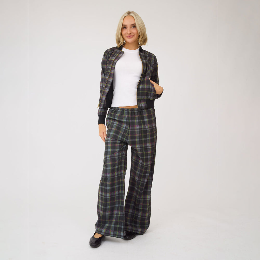 Front view of Bomber Jacket, Aspen Plaid showcasing its dark plaid pattern on a model against a white background