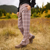 Side view of Audrey Trouser in Toffee Plaid showcasing the wide-leg fit on a model against an autumn field