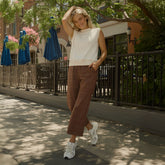 Full-length view of cream Somerset Knit Sweater Vest showcasing its sleeveless knit design on a model outdoors