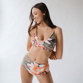 Front view of Pixie High-Waisted Bottoms with colorful floral print and high-waisted fit on a model against a light background