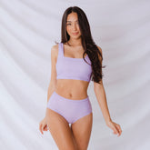 Front view of Periwinkle High-Waisted Bottoms showcasing the high-waisted fit on a model against a white draped background